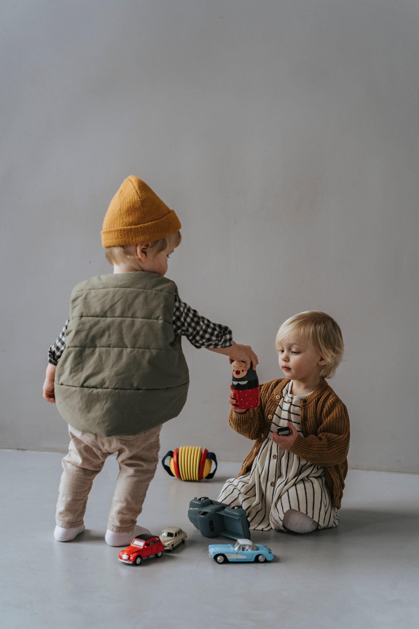 Two young children playing together in cosy everyday layers